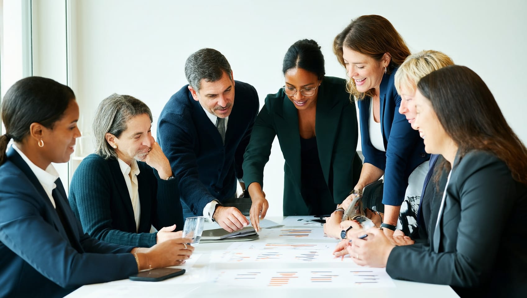 JULY Commercial advisors reviewing a portfolio strategy together at a conference table