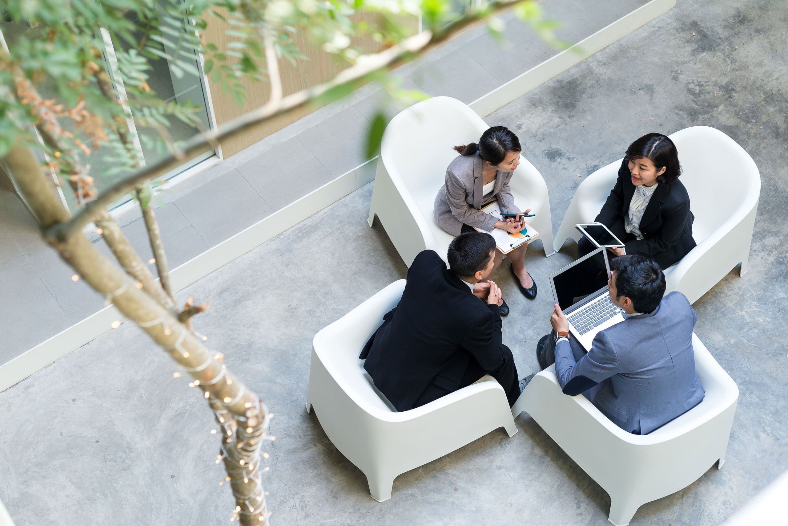 Business team meeting in an open-air office courtyard
