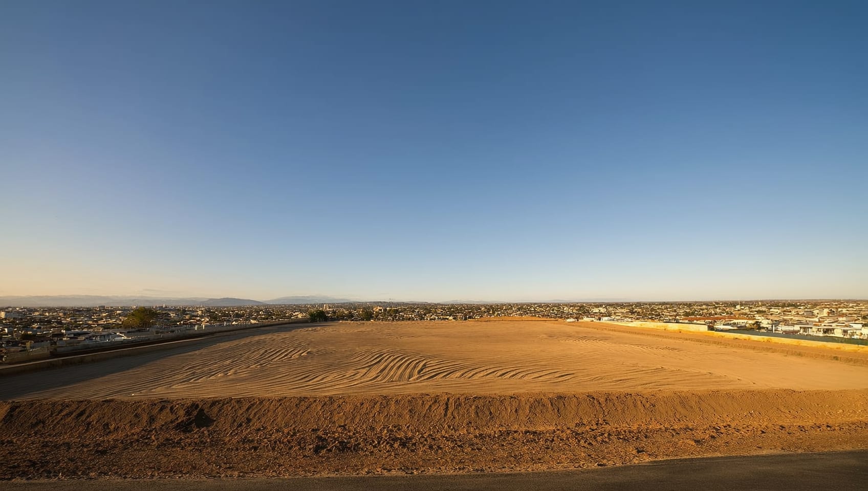 Open development land parcel on the edge of a growing commercial district