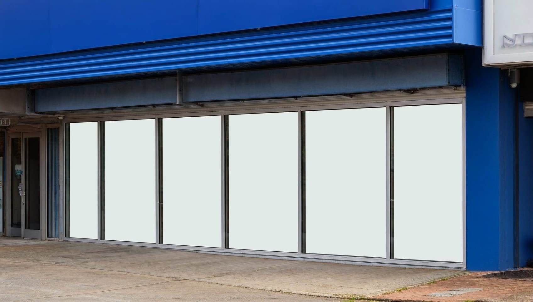 Empty commercial storefront with a blank lease sign in the window