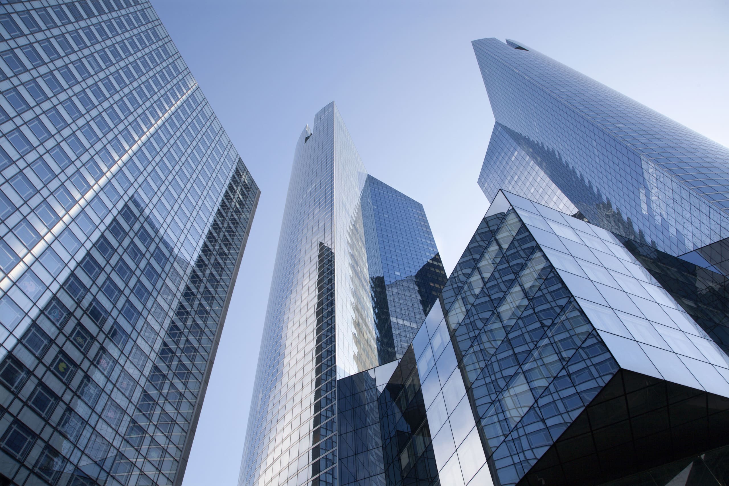 Looking up at modern glass high-rise buildings