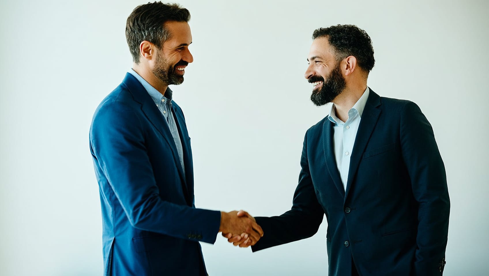 Two colleagues shaking hands after closing a commercial real estate deal